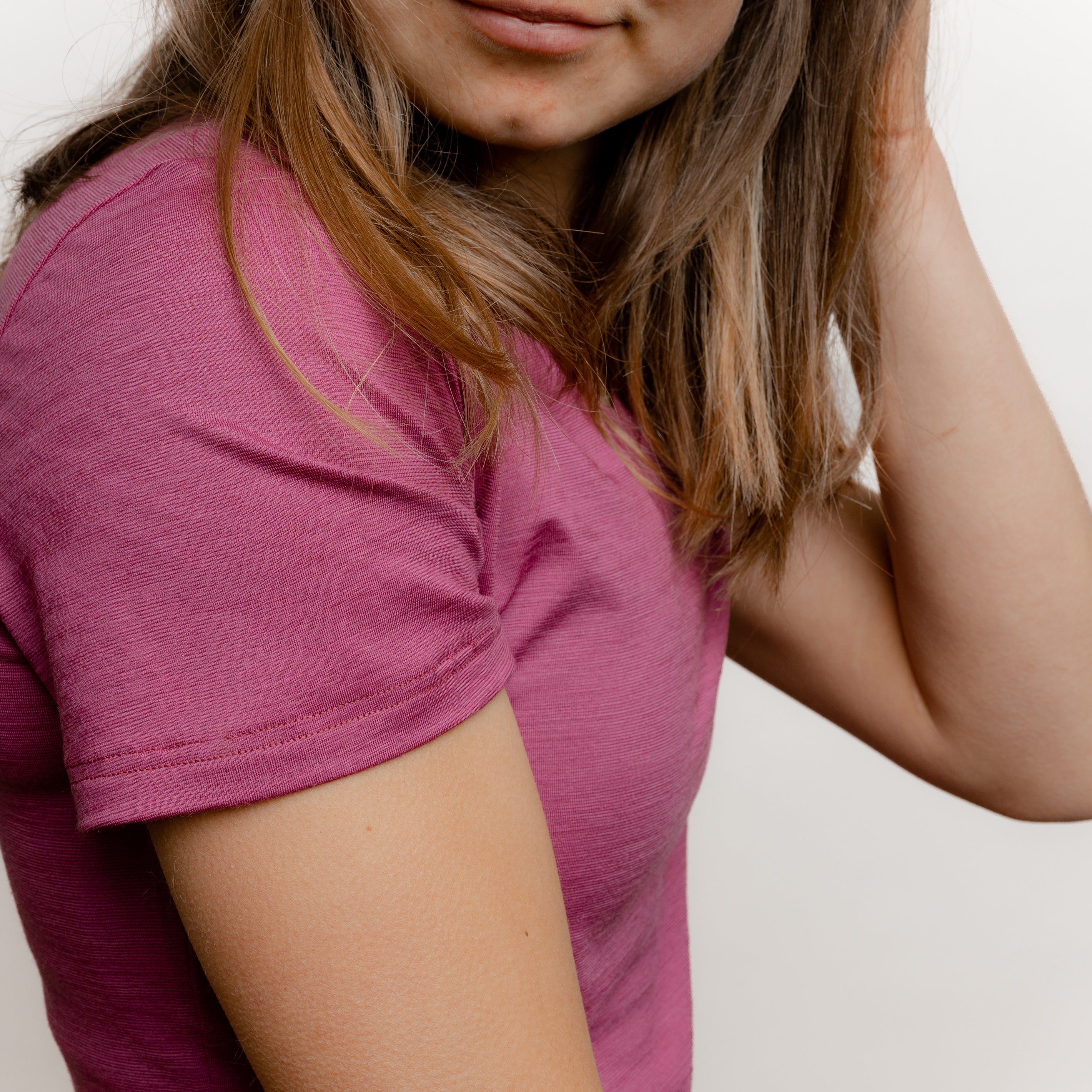 Model mit Merino Damen Shirt mit V-Ausschnitt von Tom Fyfe in Brombeere seitliche Nahaufnahme Schulter