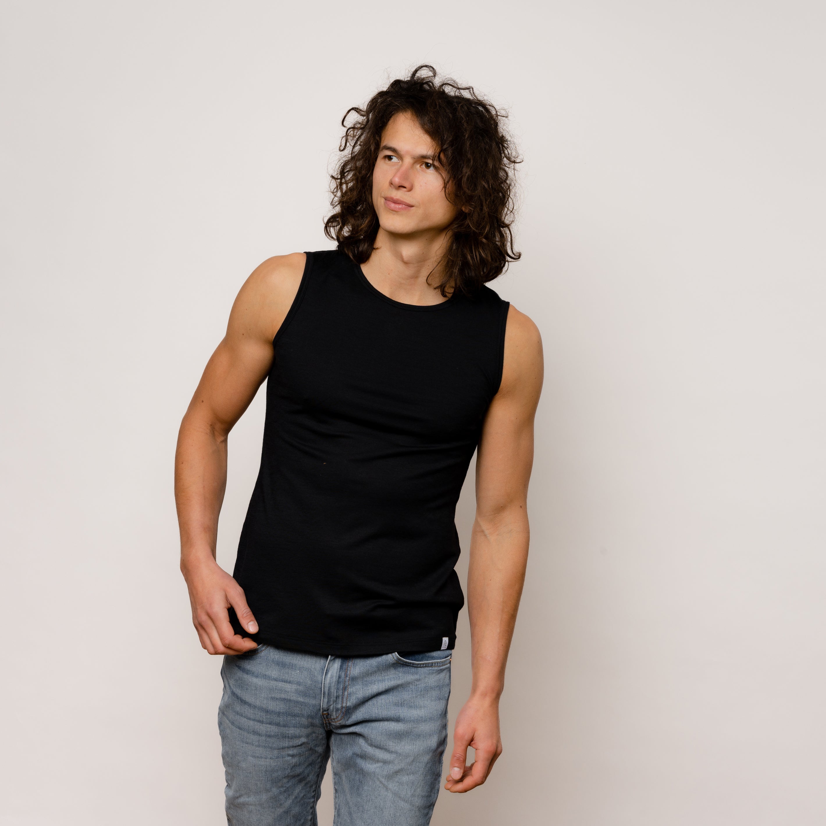 Model mit Merino Herren Tanktop Frontansicht von Tom Fyfe in Schwarz