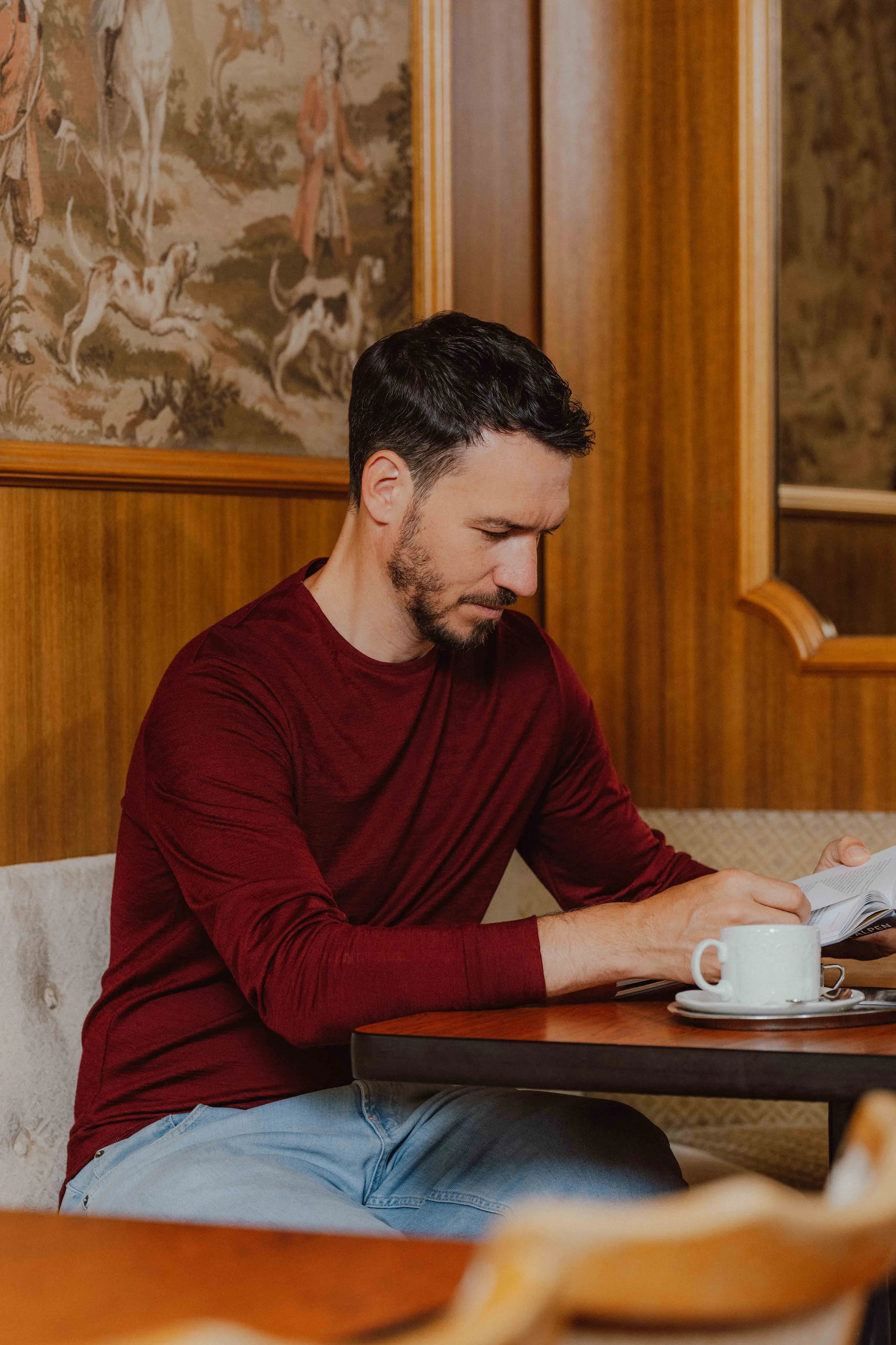 Felix Neureuther im TOM FYFE Merino Longsleeve Herren in Burgundy beim Lesen.