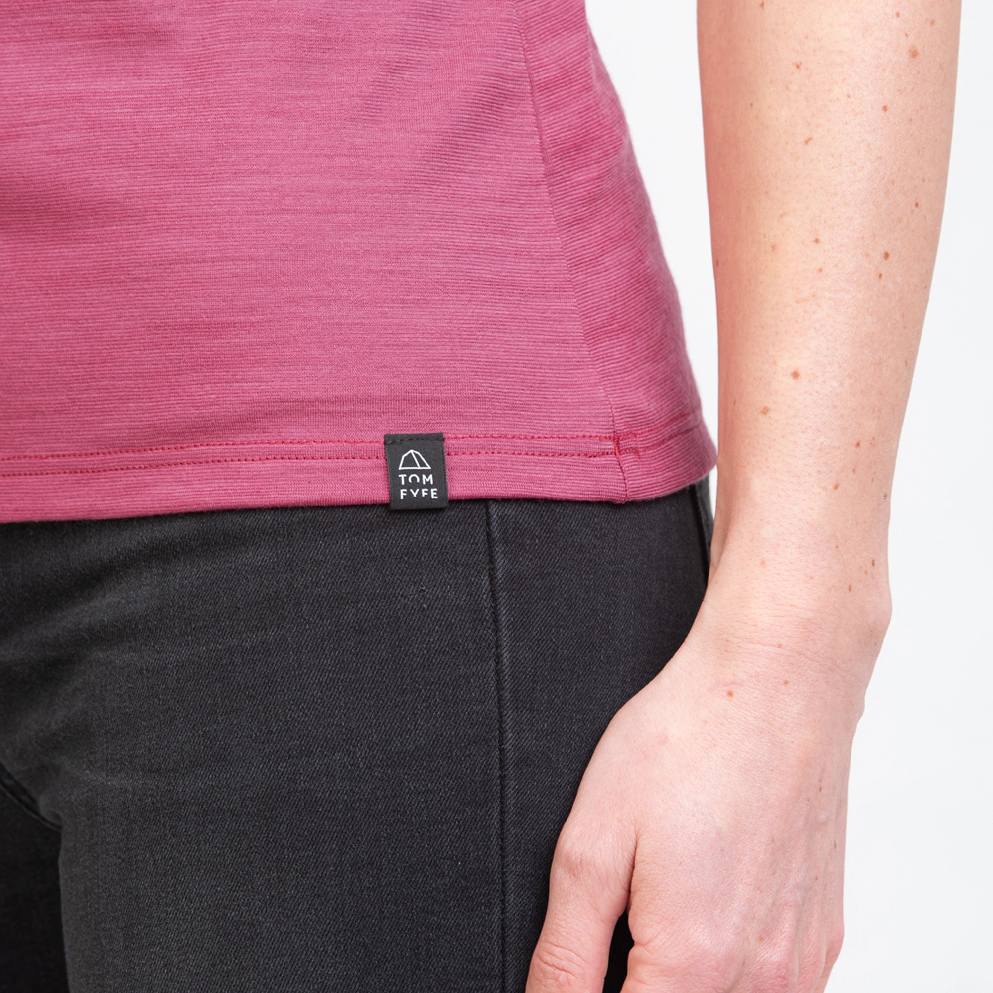 Model mit Merino Damen Shirt mit angenaehtem Stofflabel mit Logo von TOM FYFE in Brombeere 