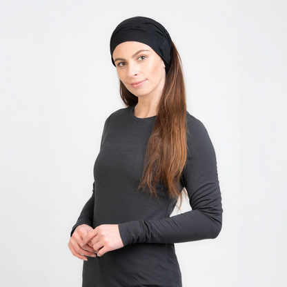 Weibliches Model mit Merino Schlauchschal Multifunktionstuch von TOM FYFE in Schwarz als Kopfbedeckung 
